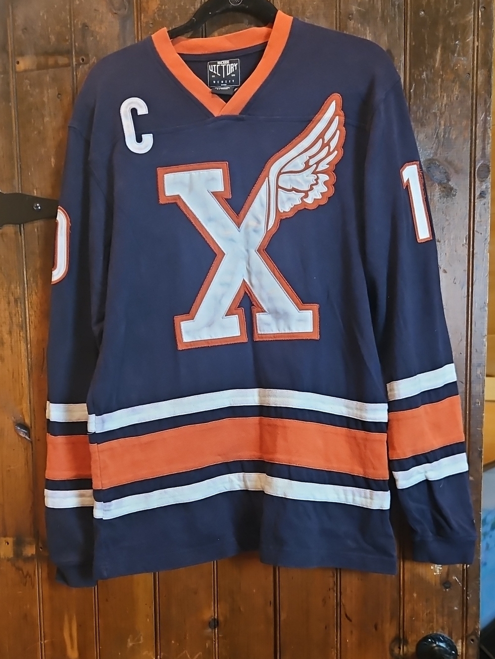 10.Deep Navy and Orange Hockey Jersey with Winged X Logo